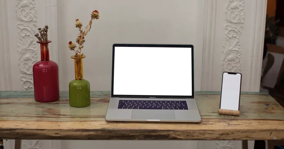 Laptop y smartphone para comparar una página web con las redes sociales